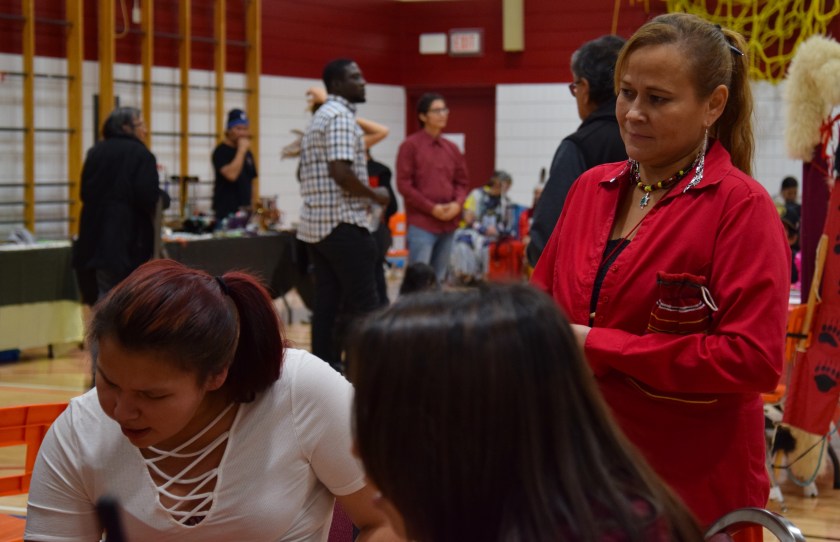 Organizer Candace Arrow watching female drum group